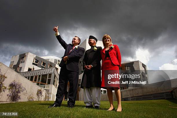 Alex Salmond SNP leader and Nicola Sturgeon deputy leader stand with Bashir Ahmed, the Scottish Parliament's first Asian MSP, after taking their oath...