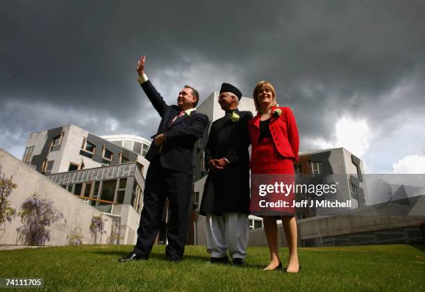 Alex Salmond SNP leader and Nicola Sturgeon depute leader stand with Bashir Ahmed, the Scottish Parliament's first Asian MSP, after taking their oath...
