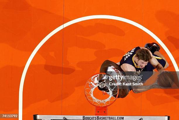 Troy Murphy of the Indiana Pacers battles to shoot against Emeka Okafor of the Charlotte Bobcats on April 6, 2007 at Charlotte Bobcats Arena in...