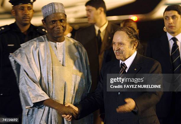 Algerian President Abdelazziz Bouteflika shakes hands 09 May 2007 his counterpart, Nigeria's president-elect, Umaru Yar'adua prior to their meeting...