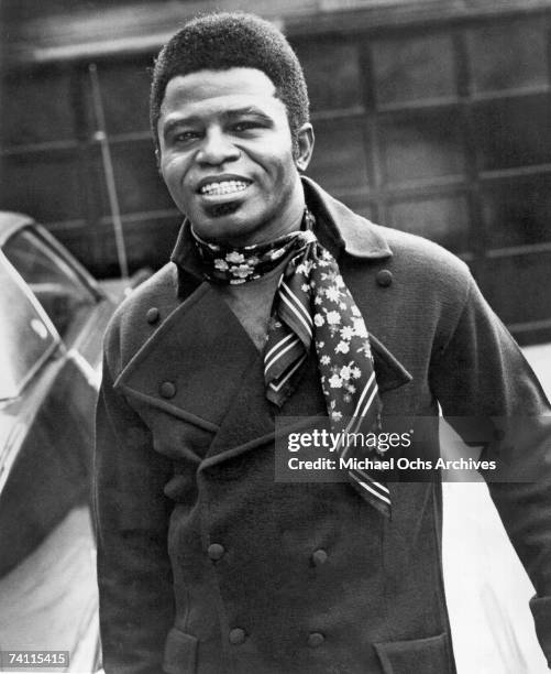 Soul singer James Brown poses for a portrait wearing a scarf in circa 1965.