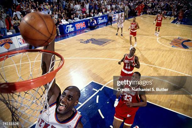 Anthony Mason of the New York Knicks dunks against Vernon Maxwell of the Houston Rockets during Game Five of the NBA Finals played on June 17, 1994...