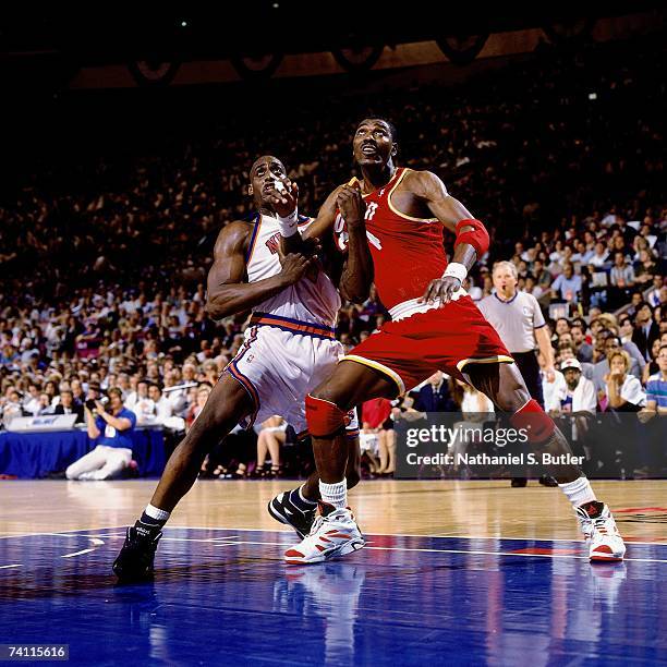 Hakeem Olajuwon of the Houston Rockets battles for position against Anthony Mason of the New York Knicks during Game Four of the NBA Finals played on...