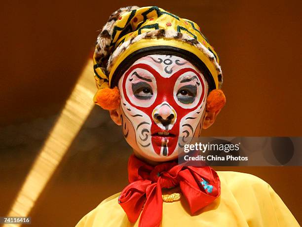 Young student performs as the "Monkey King" at the Peking Opera on stage to celebrate the 20th annivisary of the Jinfan Chorus on May 9, 2007 in...