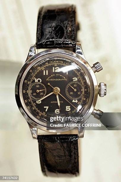 An employee of auction company Antiquorum displays, 10 May 2007 in Geneva, a Rolex watch sold to a prisoner of war during World War II, with the...