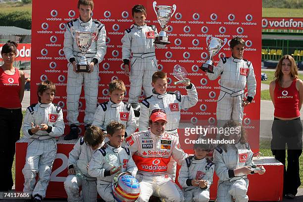 In this handout photograph provided by Vodafone, Fernando Alonso and friends during the Vodafone Go-Karting Challenge prior to the Spanish Grand Prix...