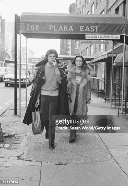 Belgian-born American fashion designer Diane von Furstenberg walks down a sidewalk with her husband, Swiss baron Egon von Furstenberg , New York, New...