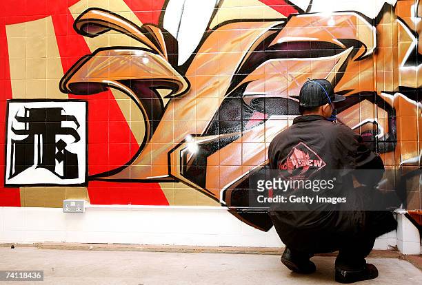 Japanese graffiti artist Kress nears completion of artwork on the wall of StolenSpace gallery prior to tonight's exhibition opening and launch of the...