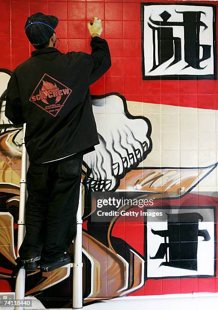 Japanese graffiti artist Kress nears completion of artwork on the wall of StolenSpace gallery prior to tonight's exhibition opening and launch of the...