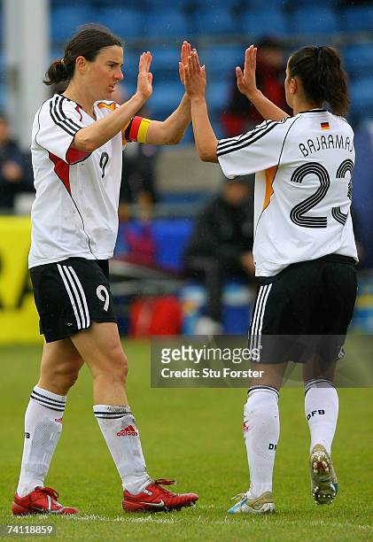 Germany captain Birgit Prinz celebrates with Fatmire Bajramaj after opening the scoring, during the UEFA Womens Championship Qualification Round...
