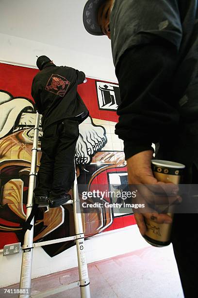 Japanese graffiti artists Kress and Esow near completion of their artwork on the wall of StolenSpace gallery prior to tonight's exhibition opening...