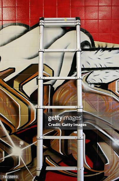 Ladder leans against Japanese graffiti artists Kress and Esow's artwork on the wall of StolenSpace gallery prior to tonight's exhibition opening and...