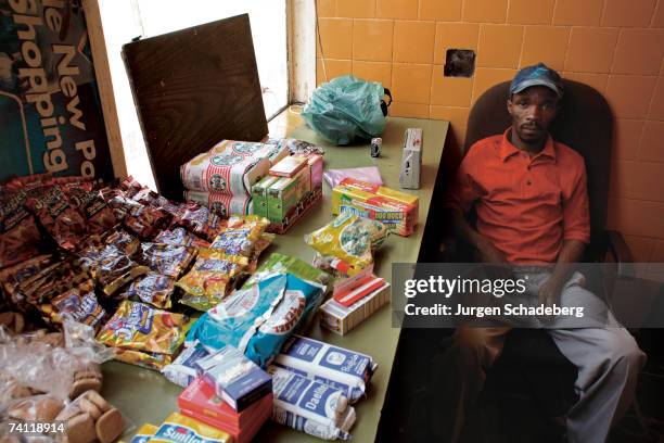 Eric Thomo runs a Spaza Shop from his room in the San Jose apartment block, Johannesburg, circa 2006. The shop can bring in R400 a month. He has...