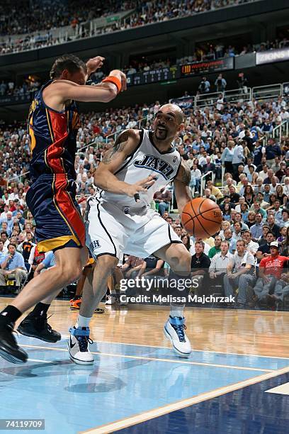 Carlos Boozer of the Utah Jazz looks for an open pass against Andris Biedrins of the Golden State Warriors in Game One of the Western Conference...