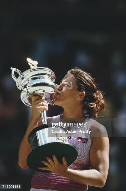 Jennifer Capriati of the United States kisses the trophy after winning the Women's Singles title against Martina Hingis at the Australian Open tennis...