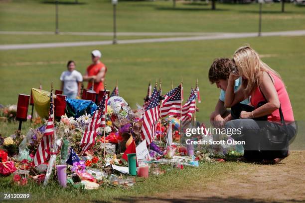 Doris Hodges and her son Josh, a Virginia Tech junior, look over mementos, photos and array of condolences left at a memorial to the victims of the...