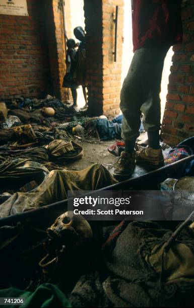 Children look at the remains of Tutsi genocide victims inside Ntarama chapel September 16, 1994 in Rwanda. Hutu militias murdered Tutsis in spring...