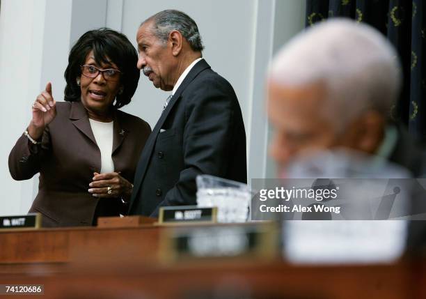 Rep. Maxine Waters talks with committee Chairman Rep. John Conyers after her turn of asking questions during a House Judiciary Committee hearing with...