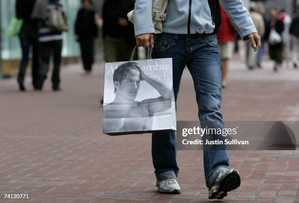 Shopper carries an Abercrombie and Fitch bag after leaving the store May 10, 2007 in San Francisco, California. U.S. Retailers are reporting slumping...