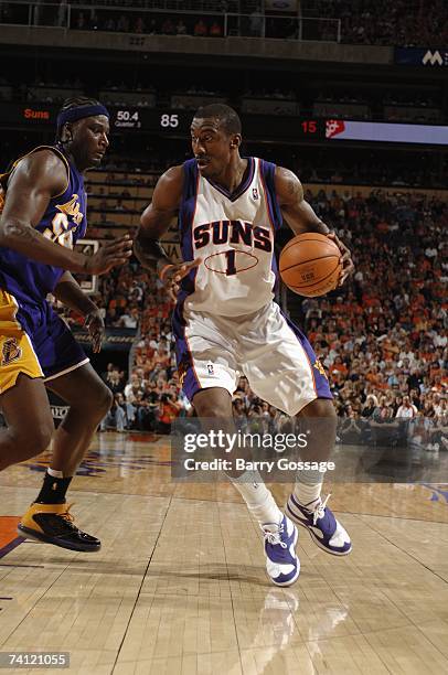 Amare Stoudemire of the Phoenix Suns moves the ball against Kwame Brown of the Los Angeles Lakers in Game Five of the Western Conference...