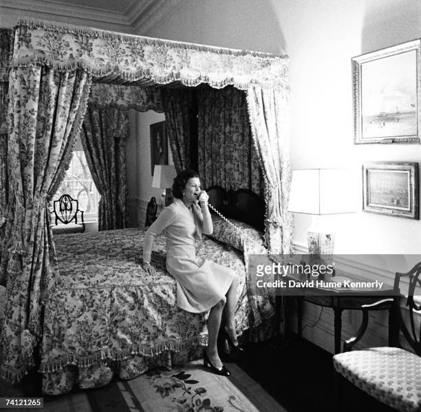 First Lady Betty Ford takes a phone call in the second floor Queen's bedroom while touring the White House Executive Residence, where presidents and...