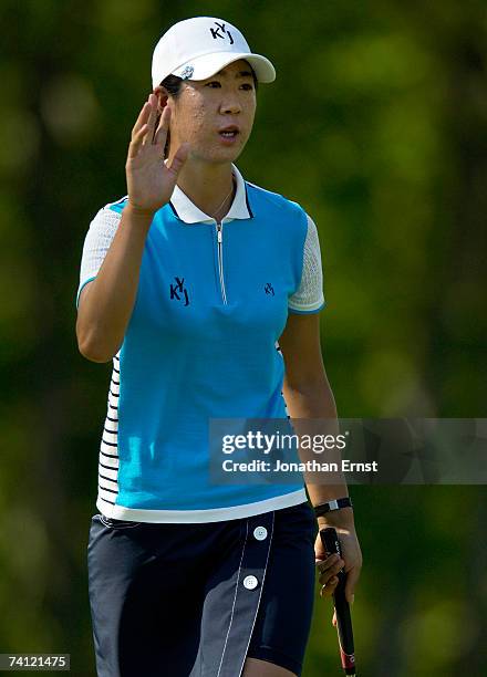 Birdie Kim of South Korea acknowledges the gallery after making a birdie putt at the 15th hole in Round 1 of the LPGA Michelob Ultra Open at...