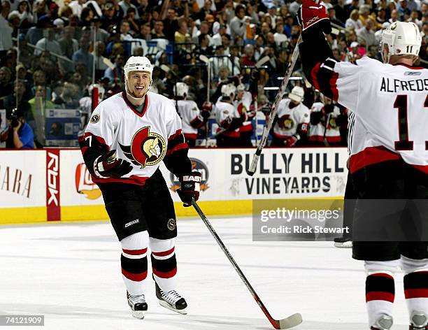 Joe Corvo of the Ottawa Senators celebrates a power-play goal by teammate Daniel Alfredsson during the first period of Game 1 of the 2007 Eastern...