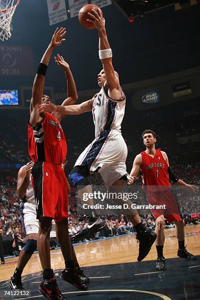 Jason Kidd of the New Jersey Nets takes the ball to the basket against Chris Bosh of the Toronto Raptors in Game Six of the Eastern Conference...