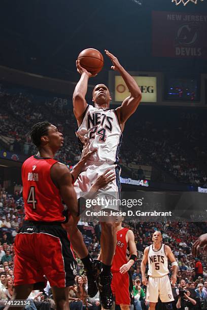 Richard Jefferson of the New Jersey Nets shoots over Chris Bosh of the Toronto Raptors in Game Six of the Eastern Conference Quarterfinals during the...