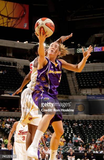 Marta Fernandez of the Los Angeles Sparks shoot around Kasha Terry of the Indiana Fever at Conseco Fieldhouse on May 10, 2007 in Indianapolis,...