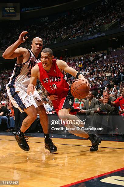 Anthony Parker of the Toronto Raptors drives to the basket around against Richard Jefferson of the New Jersey Nets in Game Six of the Eastern...