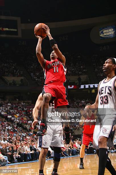 Ford of the Toronto Raptors goes up for a shot against Mikki Moore of the New Jersey Nets in Game Six of the Eastern Conference Quarterfinals during...