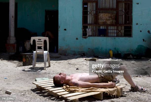 British Soldier from the Grenadier Guards Regiment is seen as he sun bath at their combat security outpost at the Delhi Patrol Base , in a location...