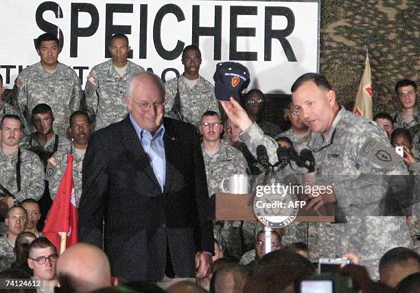 Major General Benjamin "Randy" Mixon presents visiting US Vice President Dick Cheney with a cap emblazoned with the insignia of "Task Force...