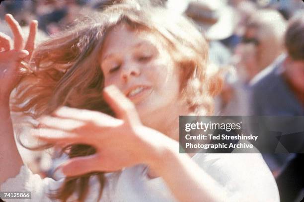 Young woman dances in the sun at the KFRC Fantasy Fair and Magic Mountain Music Festival held at the summit of Mount Tamalpais, near San Francisco,...