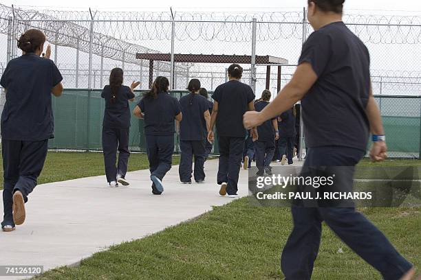 Raymondville, UNITED STATES: Female detainees walk to the exercise yard inside Homeland Security's Willacy Detention Center, a facility with 10 giant...