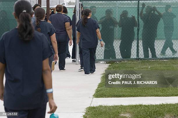 Raymondville, UNITED STATES: Female detainees walk to the exercise yard inside Homeland Security's Willacy Detention Center, a facility with 10 giant...