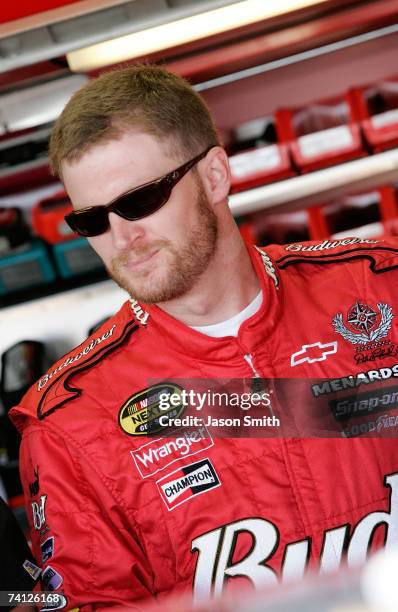 Dale Earnhardt Jr., driver of the Budweiser Chevrolet, stands in the garage prior to practice for the NASCAR Nextel Cup Series Dodge Avenger 500 on...