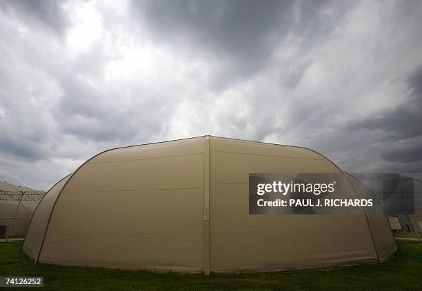 Raymondville, UNITED STATES: Clouds roll over one of the detainee's tent structures inside Homeland Security's Willacy Detention Center, a facility...