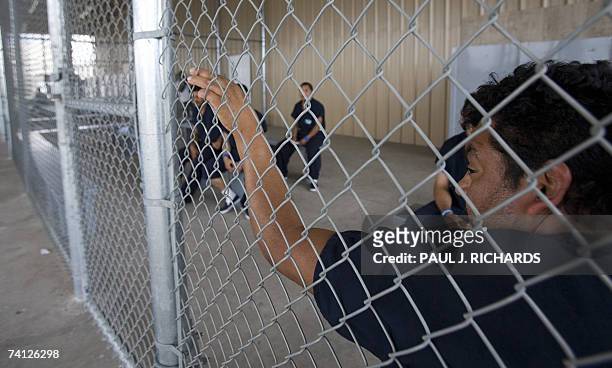 Raymondville, UNITED STATES: A detainee waits to be processed inside Homeland Security's Willacy Detention Center, a facility with 10 giant tents...