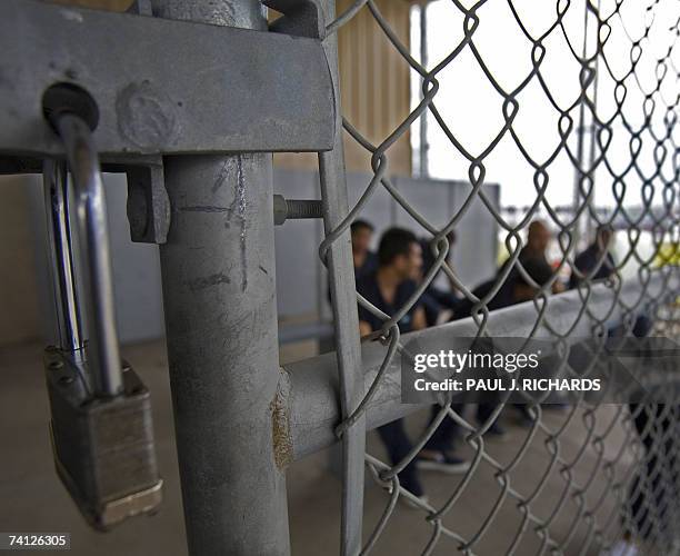 Raymondville, UNITED STATES: Detainees wait to be processed inside Homeland Security's Willacy Detention Center, a facility with 10 giant tents that...