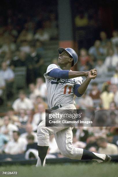 Outfielder Manny Mota of the Los Angeles Dodgers watches the ball he's just hit during a game on July 29, 1969 against the Pittsburgh Pirates at...
