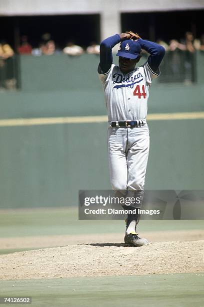 Pitcher Al Downing of the Los Angeles Dodgers winds up to throw a pitch during a game on July 22, 1971 against the Cincinnati Reds at Riverfront...