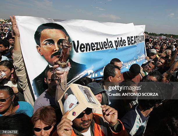 Venezuelan faithful hold a banner asking for the canonization of Venezuelan Doctor Jose Gregorio Hernandez during a mass celebrated by Pope Benedict...