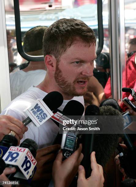 Dale Earnhardt Jr., driver of the Budweiser Chevrolet, speaks with members of the media at his hauler following practice for the NASCAR Nextel Cup...