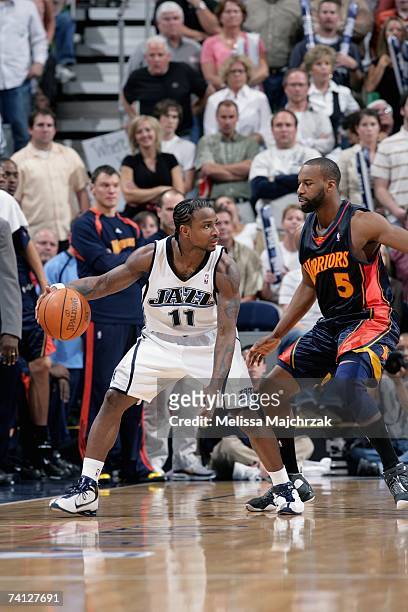 Dee Brown of the Utah Jazz is guarded by Baron Davis of the Golden State Warriors in Game One of the Western Conference Semifinals during the 2007...