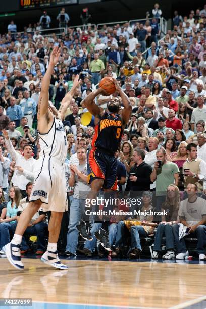 Baron Davis of the Golden State Warriors shoots over Deron Williams of the Utah Jazz in Game One of the Western Conference Semifinals during the 2007...