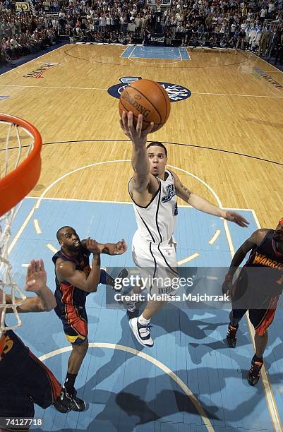 Deron Williams of the Utah Jazz lays the ball up over Baron Davis of the Golden State Warriors in Game One of the Western Conference Semifinals...