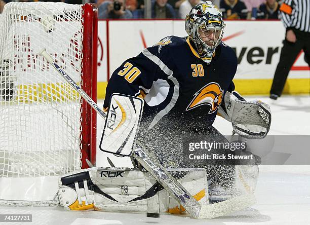 Goaltender Ryan Miller of the Buffalo Sabres hits the puck away during Game 1 of the 2007 Eastern Conference Finals against the Ottawa Senators on...