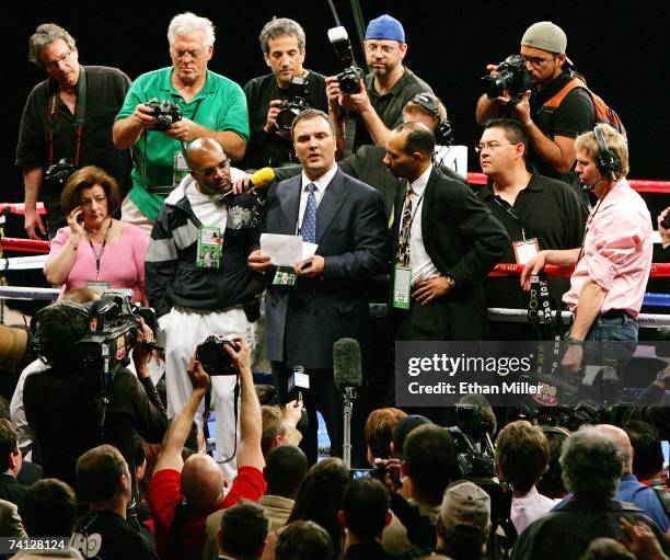 Floyd Mayweather Jr.'s manager Leonard Ellerbe looks on as Golden Boy Promotions CEO Richard Schaefer talks to members of the media about what he...